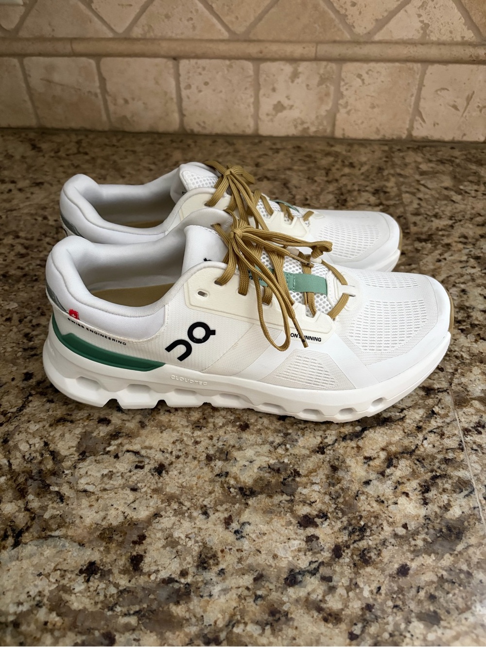 On Running White Sneakers with Green Stripe and Tan Laces